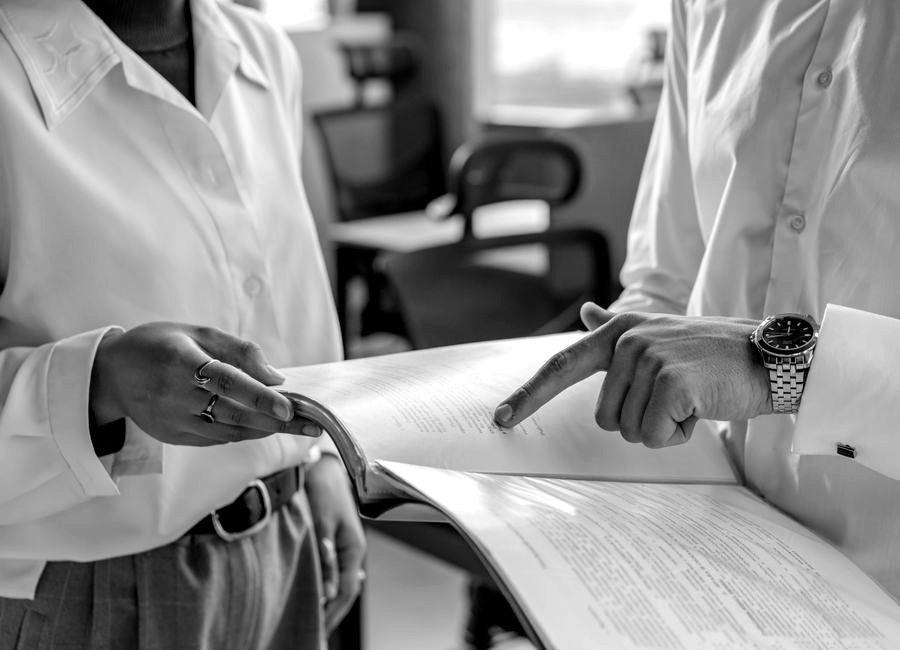 Two colleagues reviewing a business risk report together